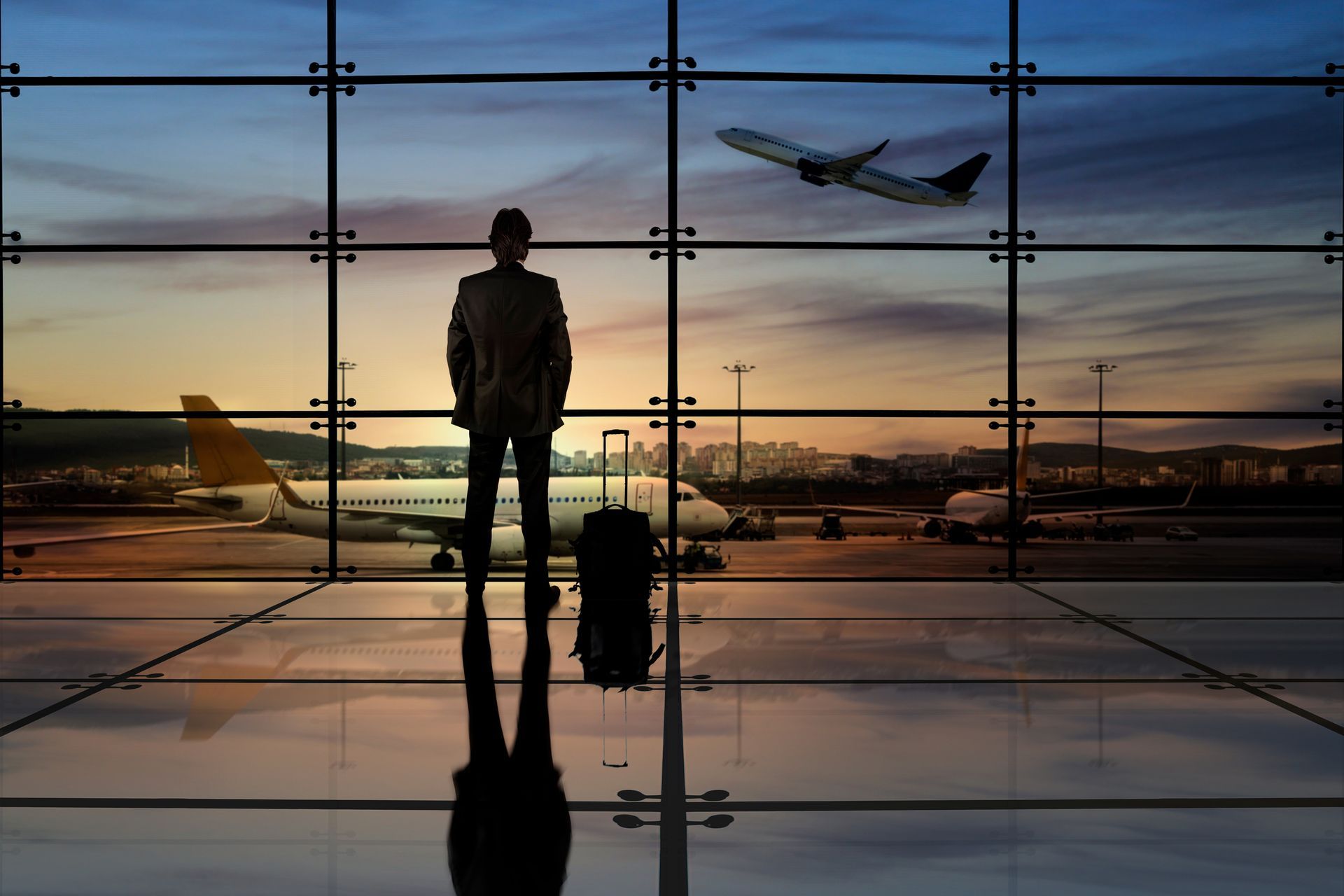 Executive traveler with luggage at an international airport terminal - Diplomatic relocation London