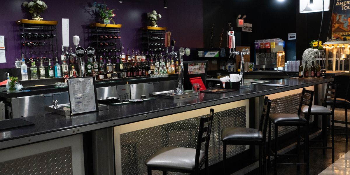 A bar in a theatre with a purple wall