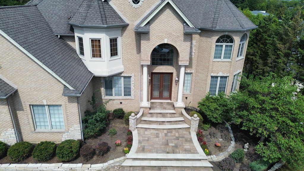 A living room with two couches, a fireplace, and a ceiling fan.