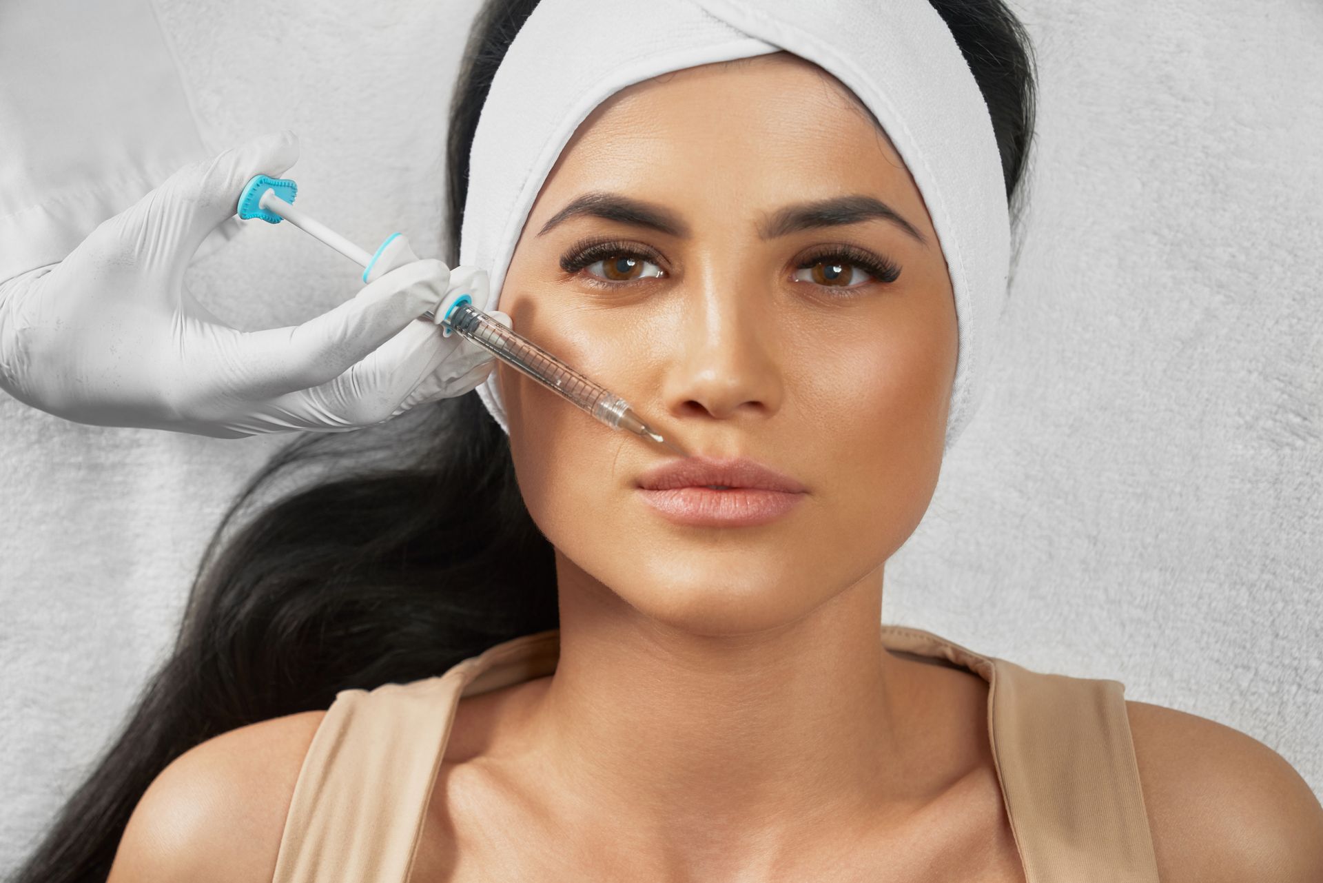 A woman is getting a botox injection in her face.