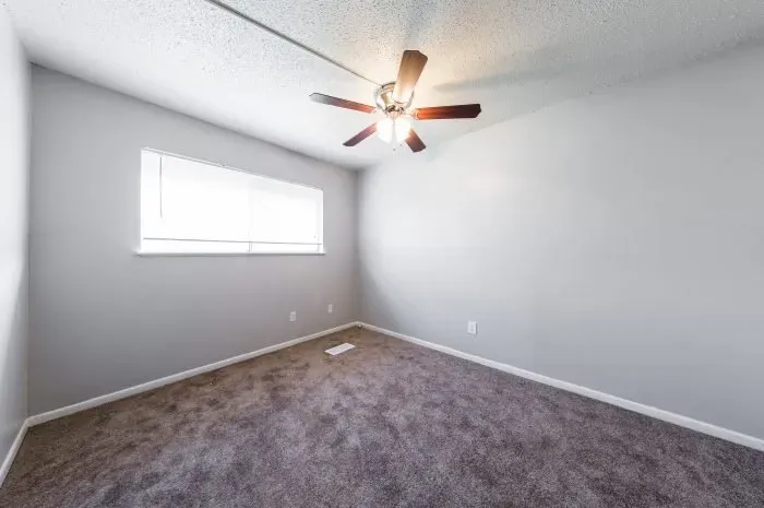 The Colony - bedroom with carpet and ceiling fan