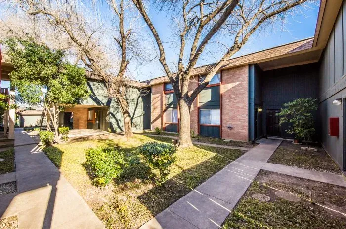 The Colony - exterior of building with grass area and trees