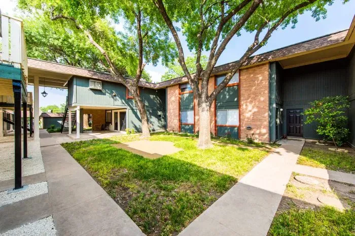The Colony - exterior of building with grass area and trees