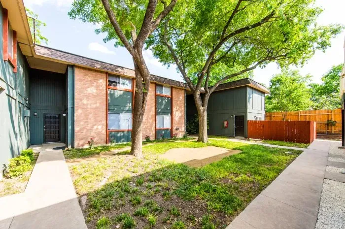 The Colony - exterior of building with grass area and trees