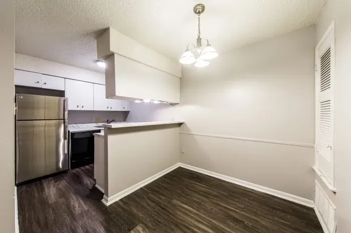 The Colony -  dining area with grey laminate wood flooring
