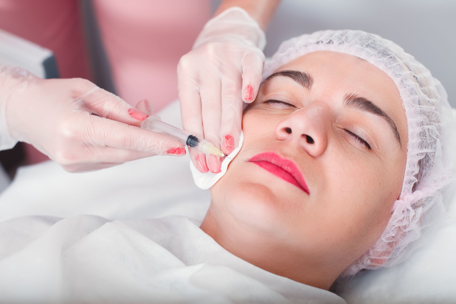 a woman is getting a facial treatment at a beauty salon