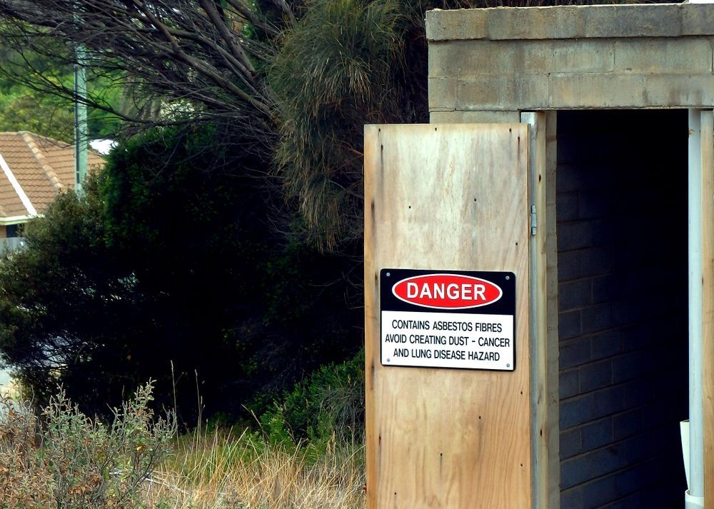 A Danger Sign that Says Contains Asbestos Fibres — Goat Collective in Gold Coast, QLD