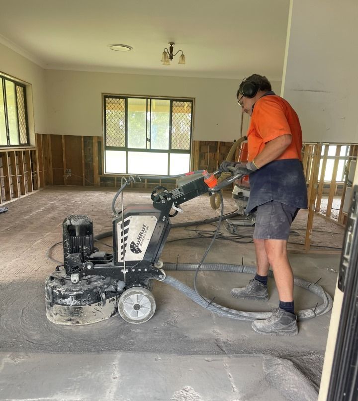 A Man is Using a Machine to Grind the Floor in a Room — Goat Collective in Tintenbar, NSW