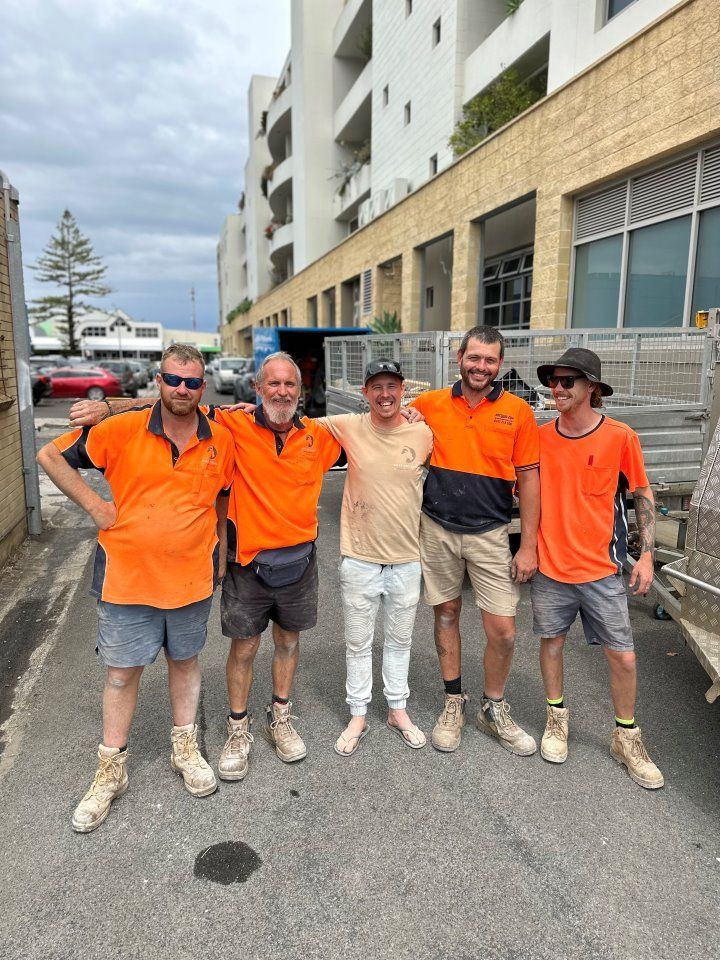 A Group of Men in Orange Shirts Are Posing for a Picture — Goat Collective in Tintenbar, NSW