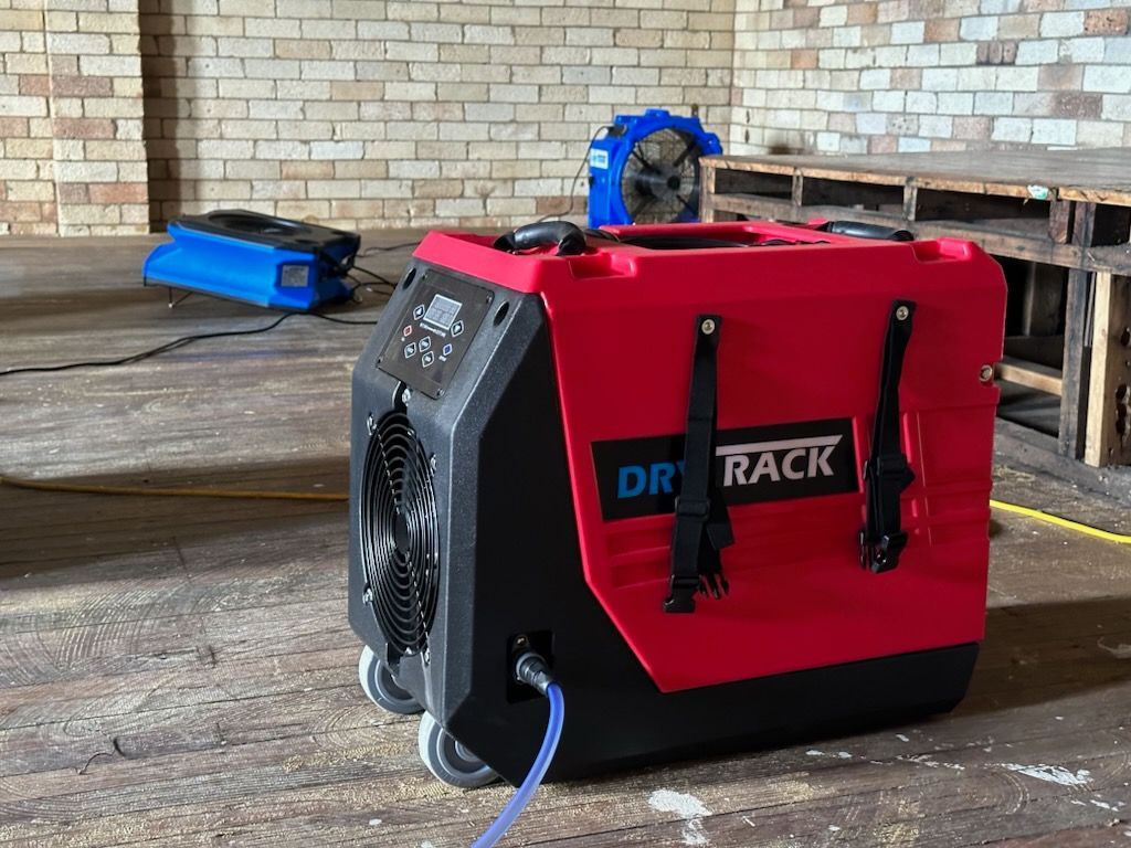 A Red and Black Machine is Sitting in a Room Next to a Brick Wall — Goat Collective in Tintenbar, NSW