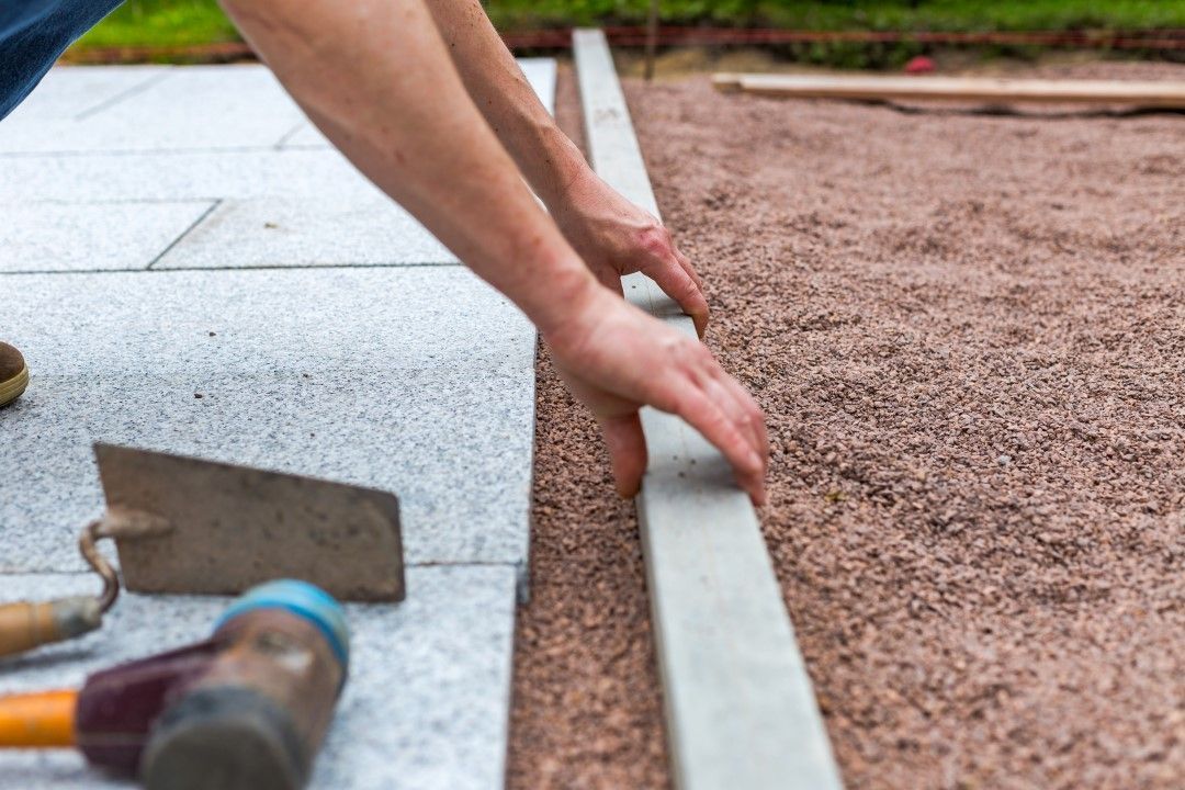 A Man is Laying a Concrete Curb on a Patio — Goat Collective in Tintenbar, NSW