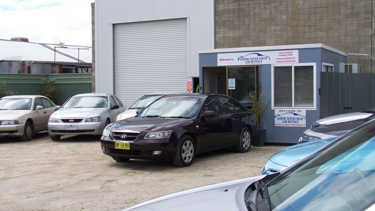 Cars Parked Outside a Small Car Dealership — Albury Super Cheap Car Rentals in Lavington, NSW