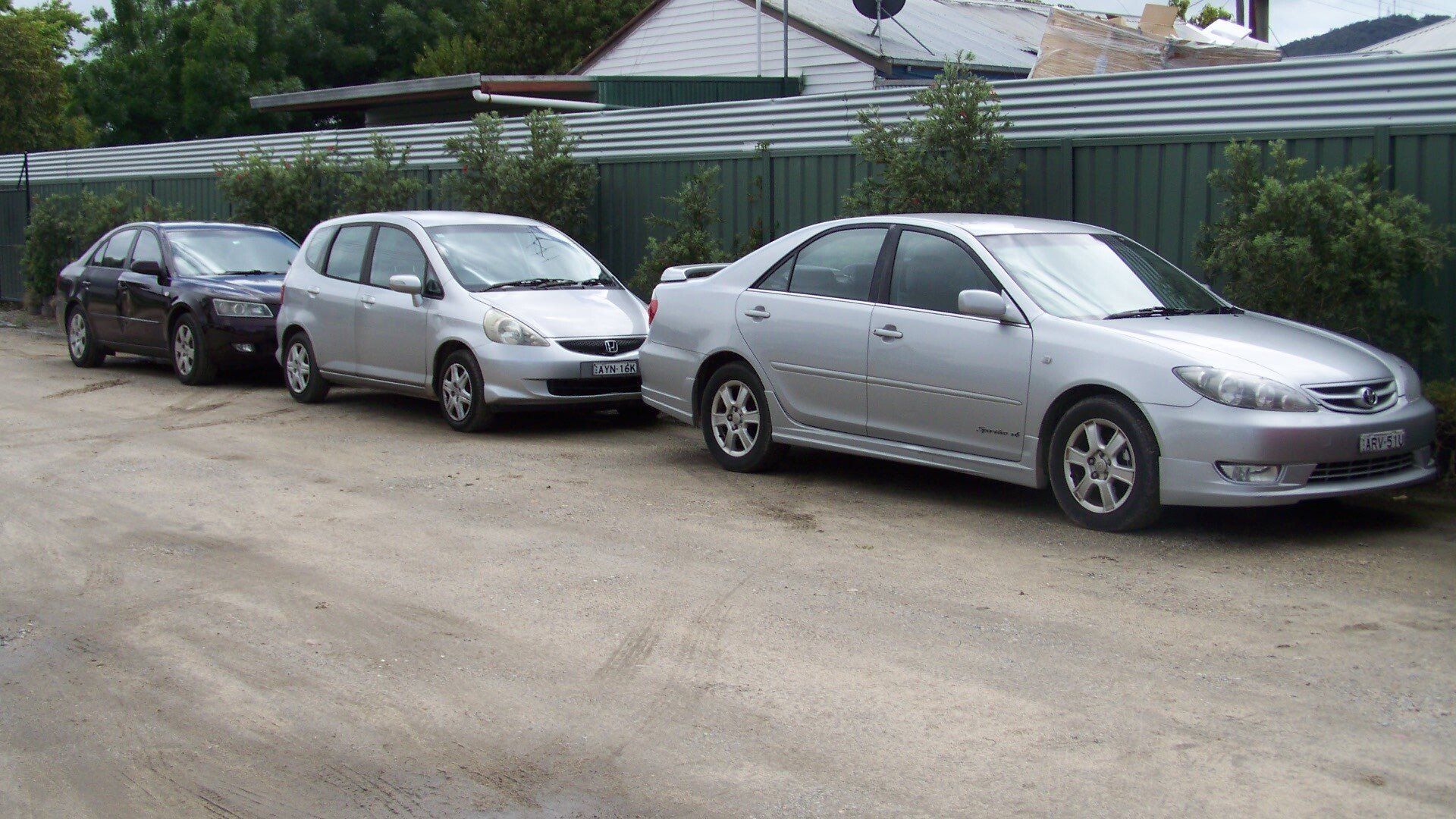 Three Parked Cars: Dark Blue, Silver Hatchback, and Silver Sedan — Albury Super Cheap Car Rentals in Lavington, NSW