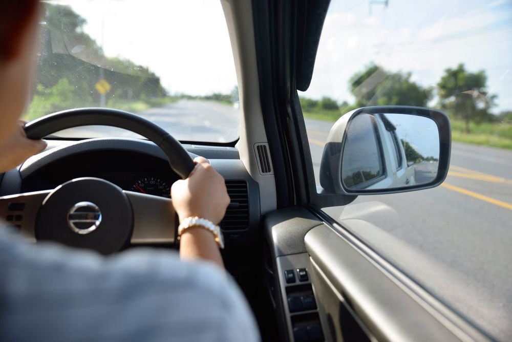 Person Driving a Car, Hands on the Steering Wheel — Albury Super Cheap Car Rentals in Lavington, NSW