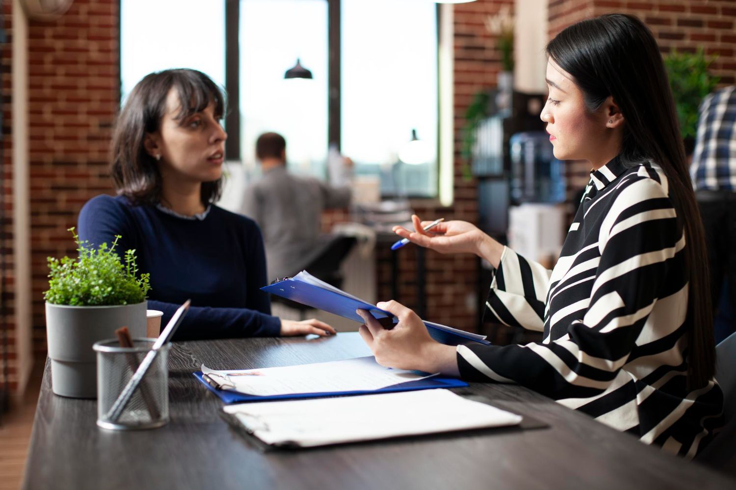 Man driving car, smiling, with family in the back seat.