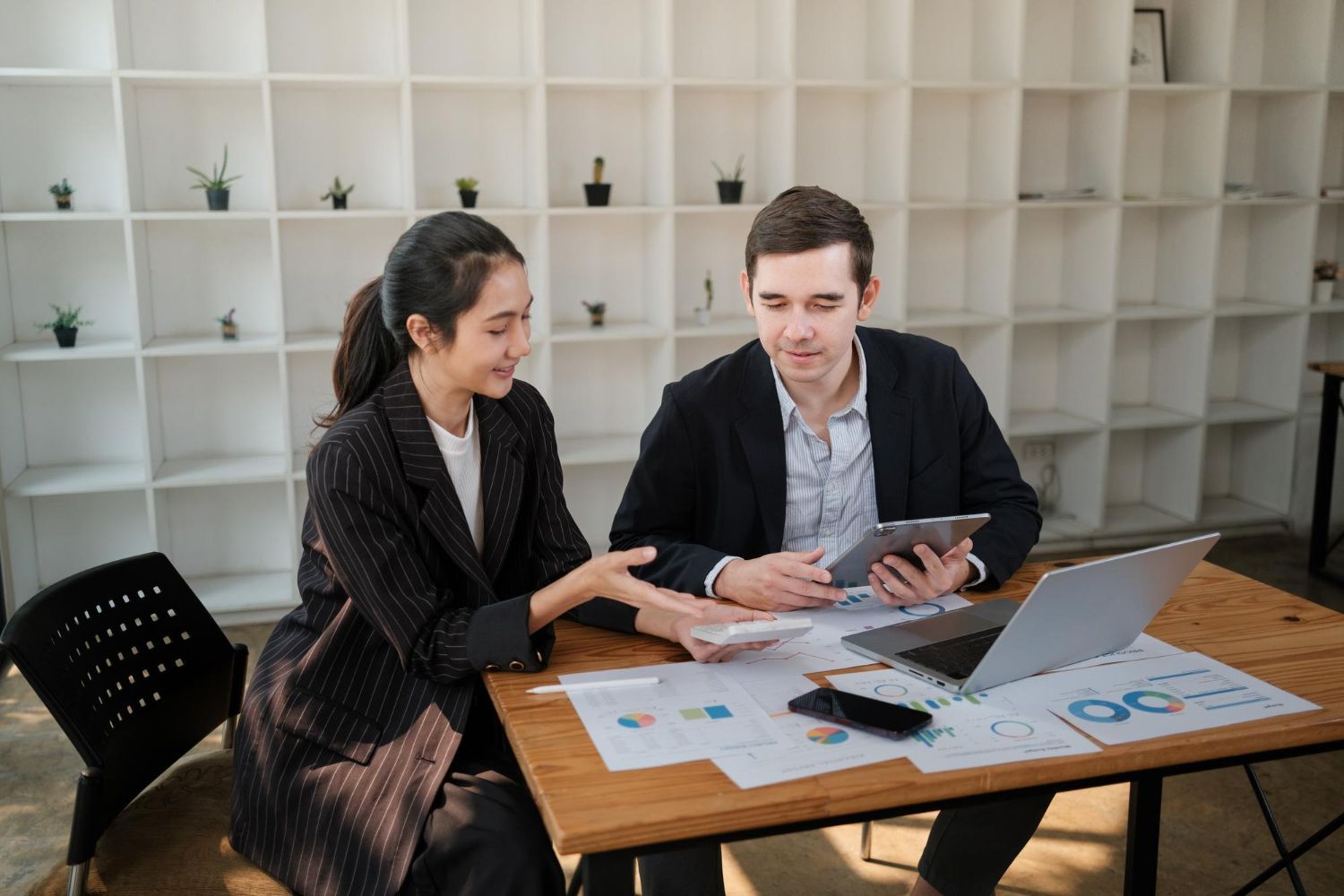 Man driving car, smiling, with family in the back seat.