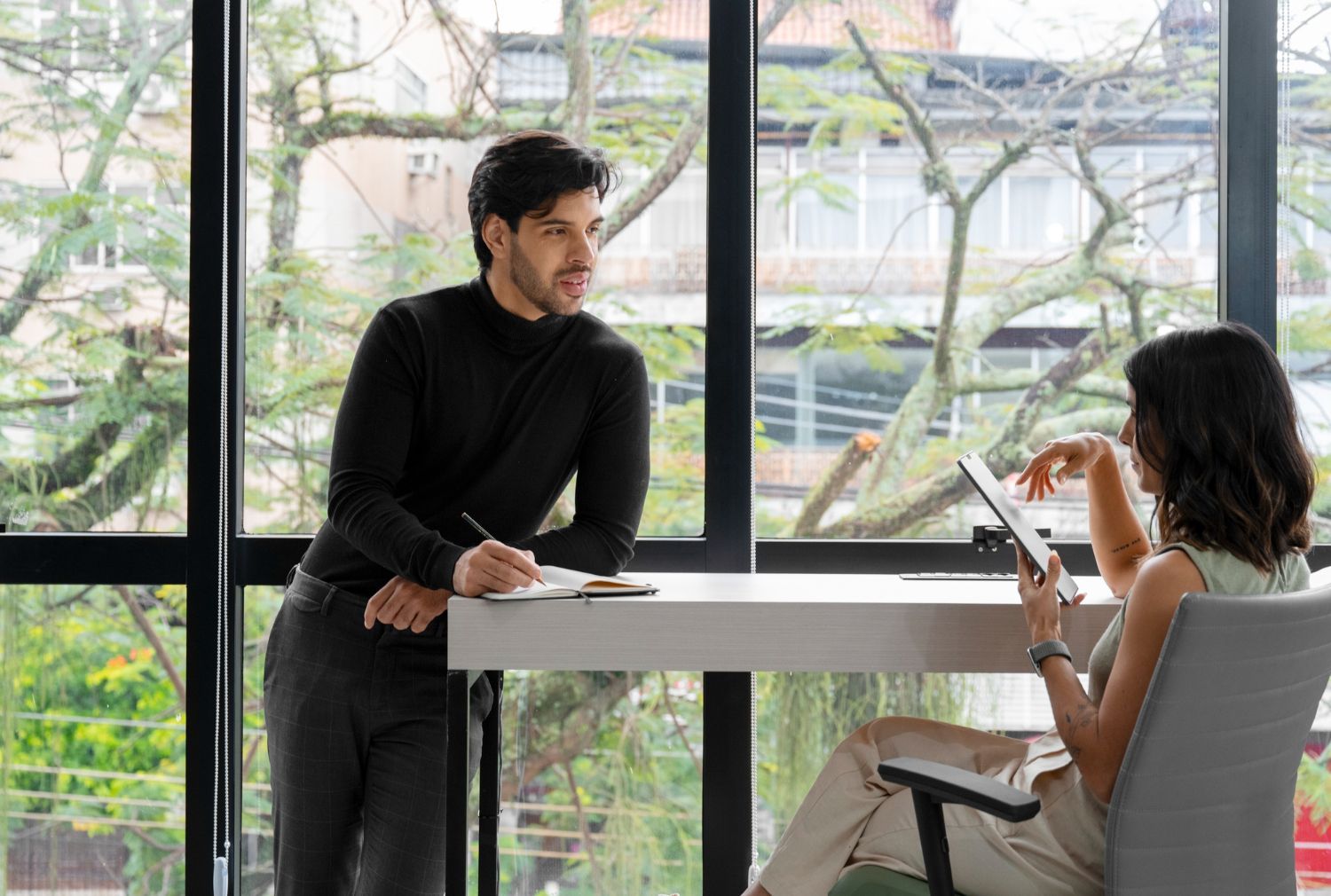Family embracing on a porch: grandparents with their children, smiling, happy.
