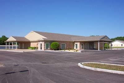 A large building with a parking lot in front of it