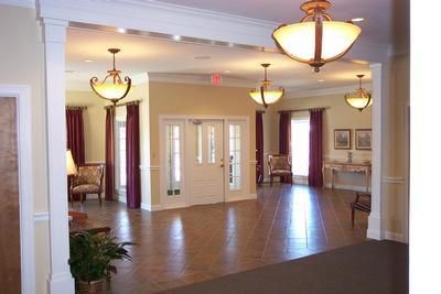 A large room with a lot of furniture and lamps hanging from the ceiling