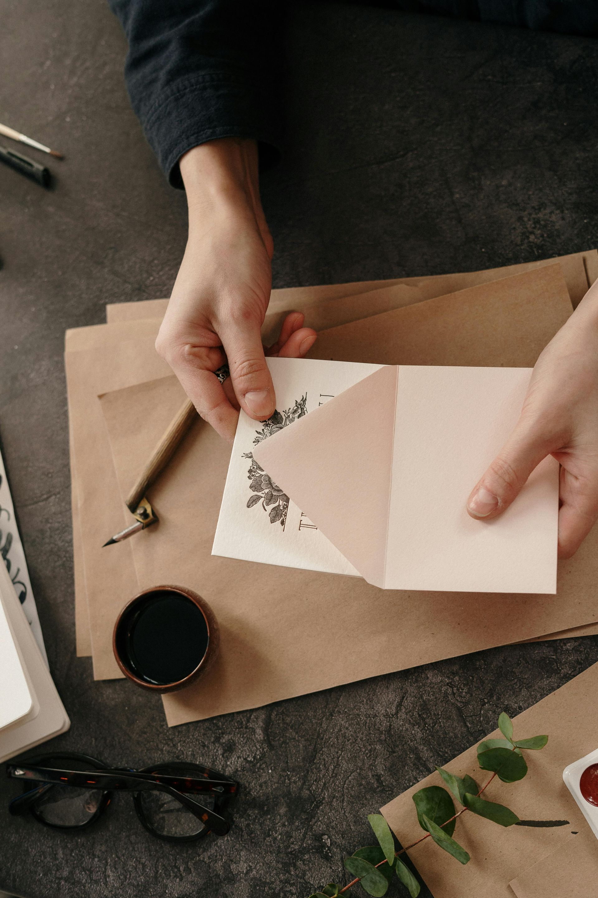 A person is holding a piece of paper in an envelope.