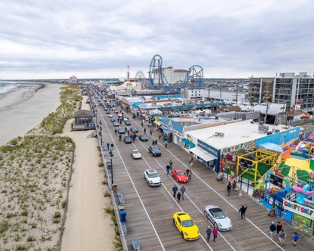 An aerial view of a boardwalk with cars driving down it.