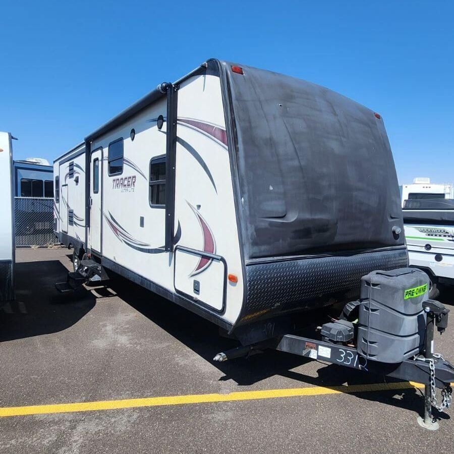 A trailer with a license plate that says 337 is parked in a parking lot