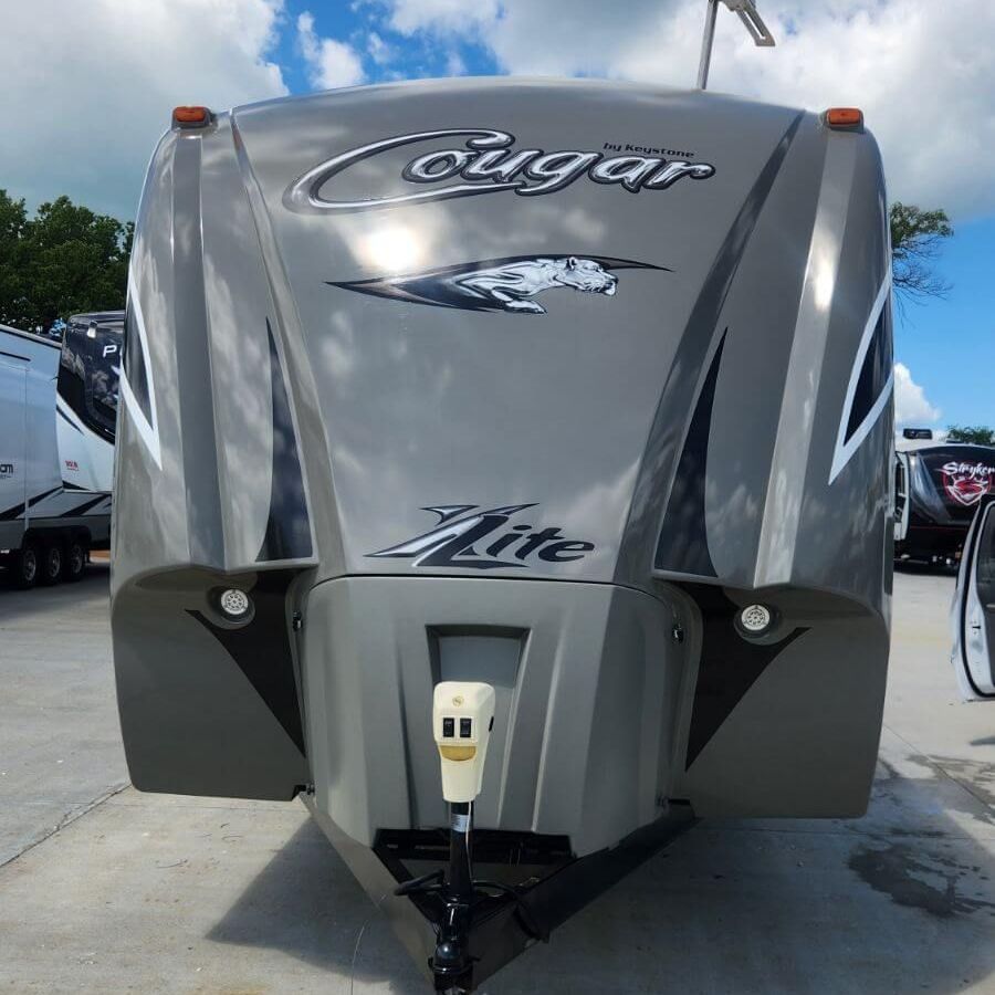 A cougar lite trailer is parked in a parking lot