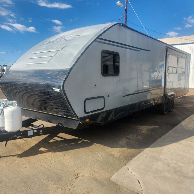 A trailer is parked on the side of the road