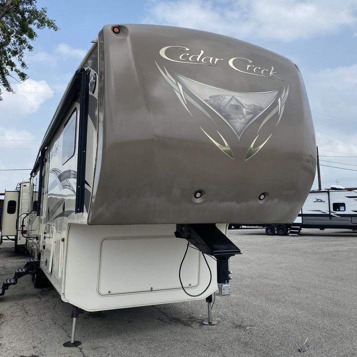 A cedar creek trailer is parked in a parking lot