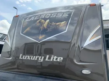 The back of a lacrosse luxury lite rv parked in a lot.