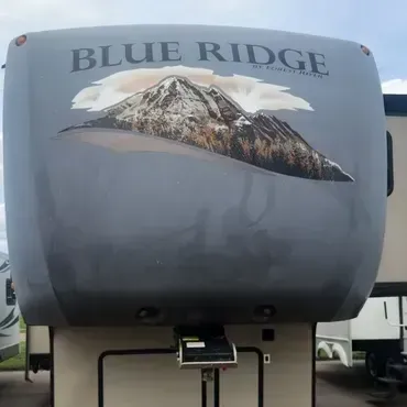 A blue ridge rv is parked in a parking lot