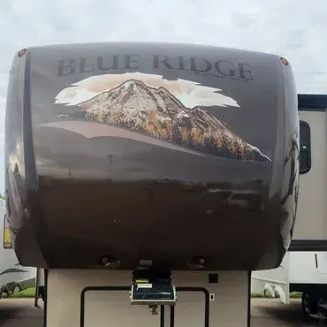 The front of a blue ridge trailer with a mountain on it.