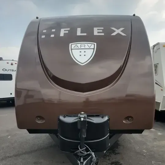 A brown flex trailer is parked in a parking lot
