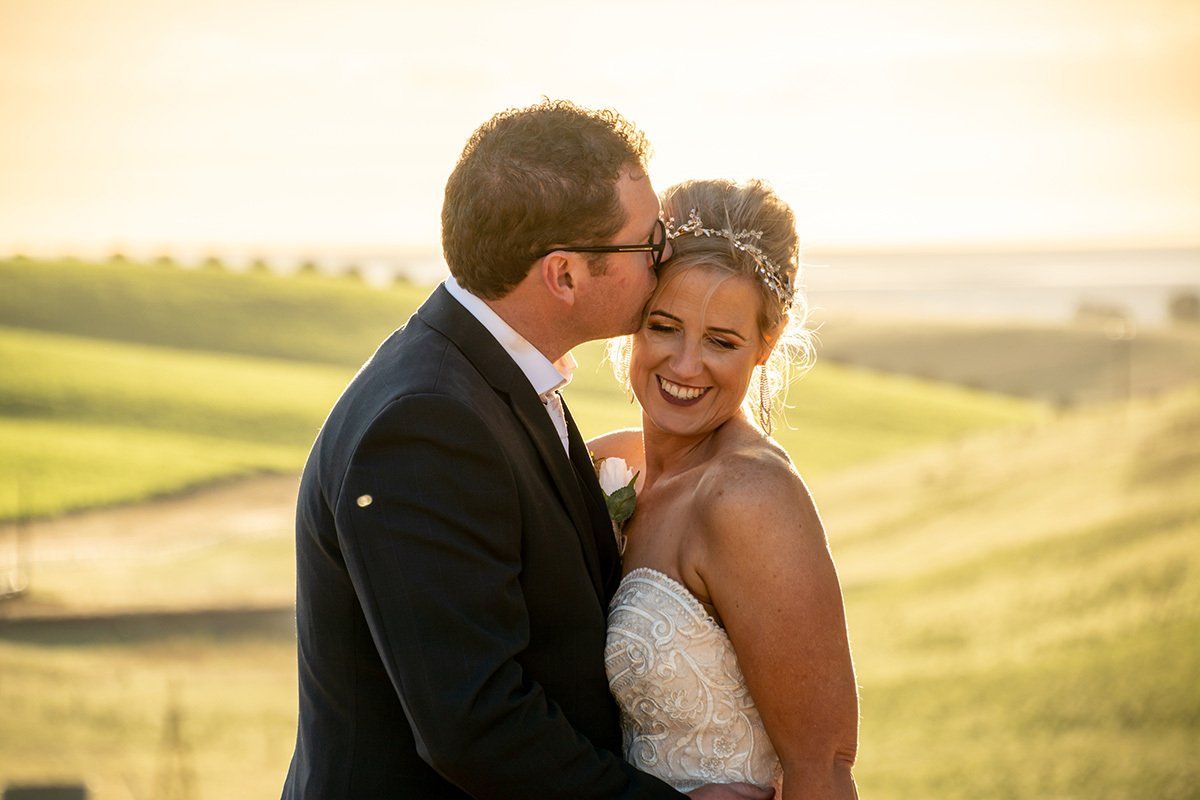 Groom Kissing his Bride on Sunset at Uleybury Wines Adelaide Wedding