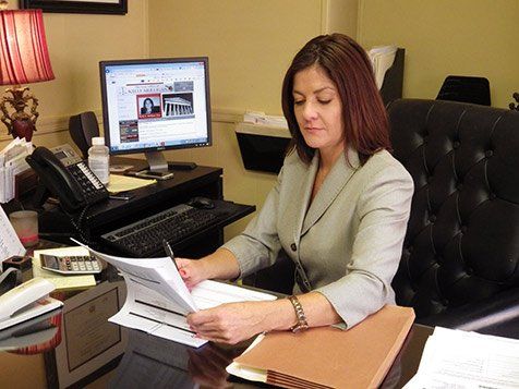 Sitting at Desk - The Law Office of Kelly Mulligan in Bel Air, MD