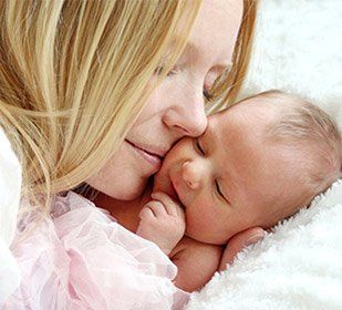 Happy mother with newborn baby — The Law Office of Kelly Mulligan in Bel Air, MD