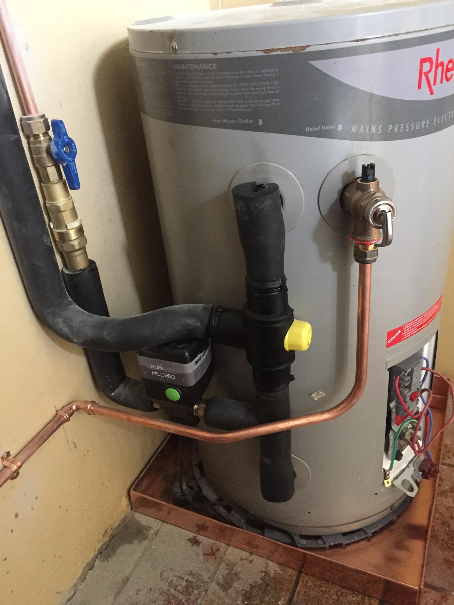 Rainwater Running Off a Brown Shingle Roof and Into a Black Gutter — Hales Plumbing & Roofing In Yeppoon, QLD