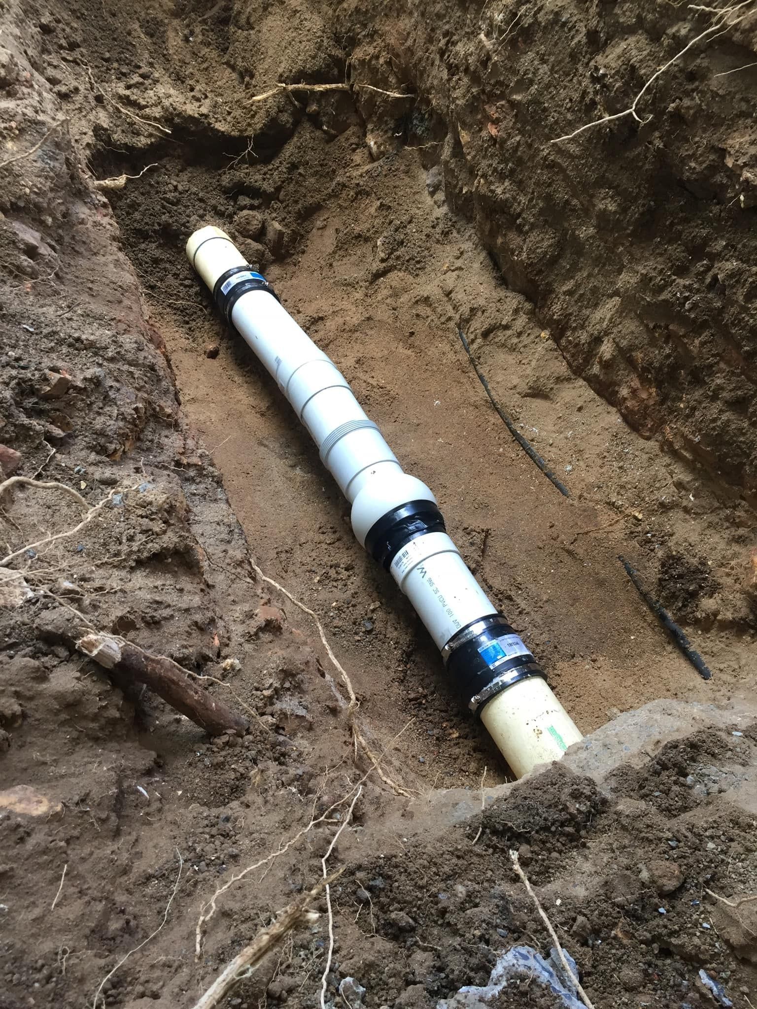 Water Heater and Heat Pump in a White-walled Utility Room — Hales Plumbing & Roofing In Gracemere, QLD