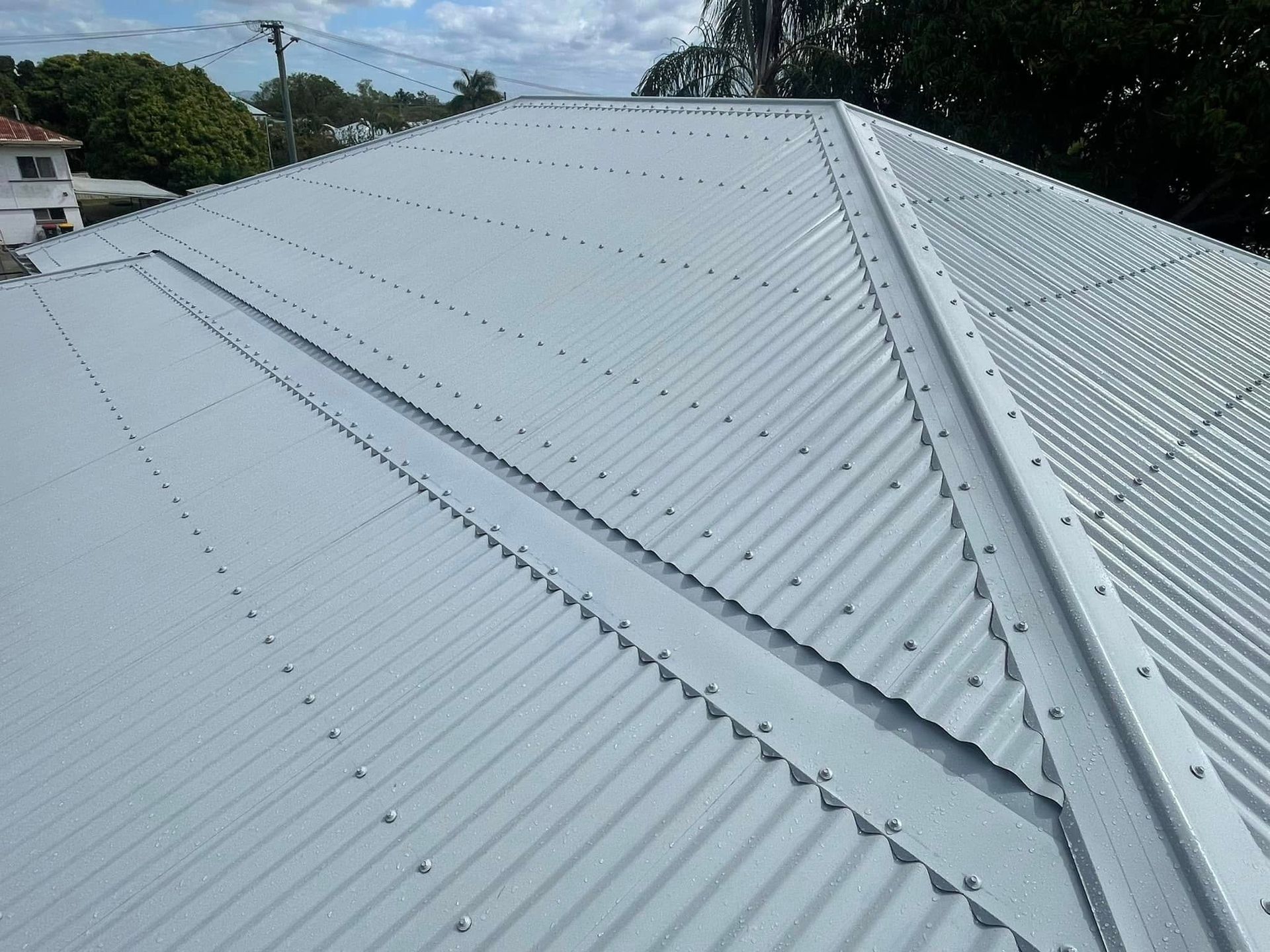 Rooftop With Exposed Beams and Insulation, Corrugated Metal Roofing — Hales Plumbing & Roofing In The Range, QLD