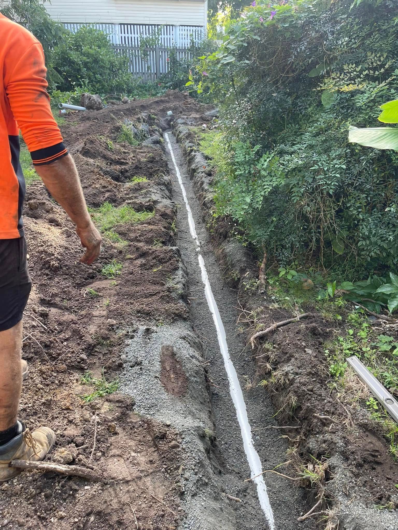 Person Using a Wrench to Tighten Plumbing Under a White Sink in a Bathroom — Hales Plumbing & Roofing In The Range, QLD