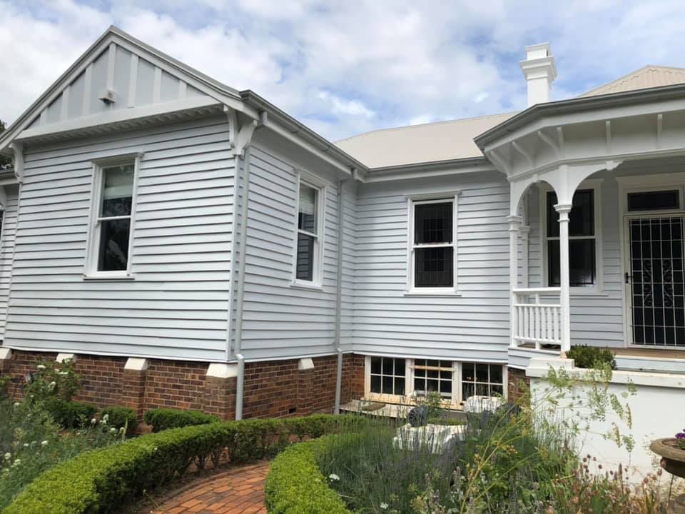 A White House With A Porch And A Walkway Leading To It — Residential Roofs in Toowoomba, QLD