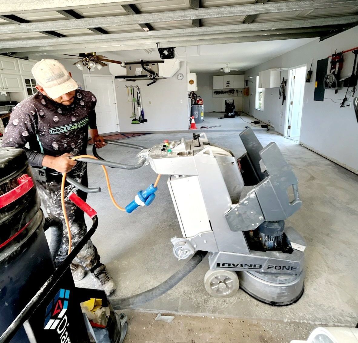 A man is working on a machine in a garage.