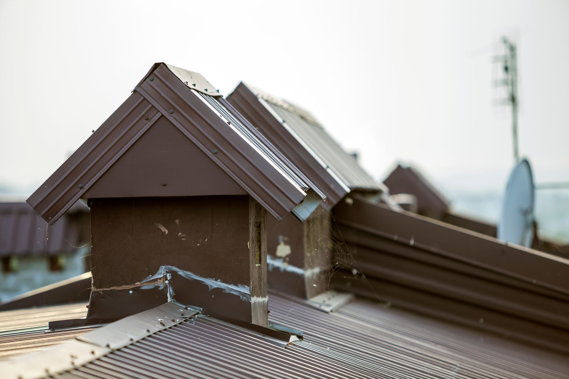 Damaged rooftop with missing shingles and exposed structure after storm damage