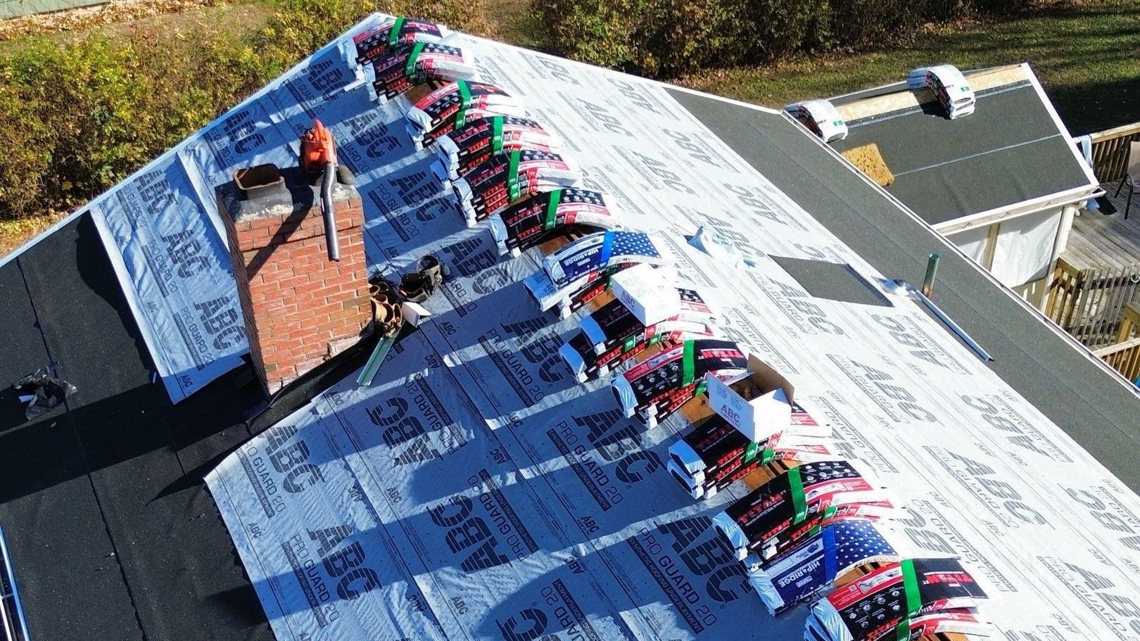 A man is working on the roof of a house.