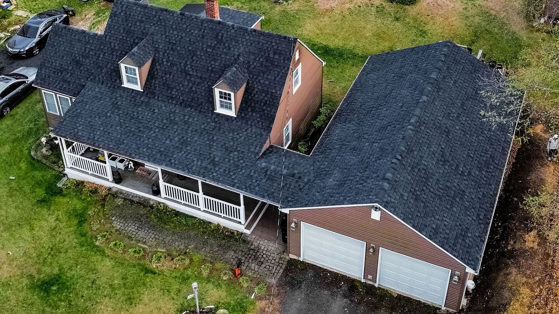 An aerial view of a house with a black roof.