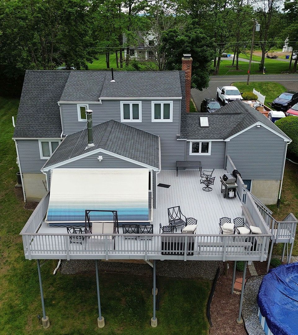 An aerial view of a house with a large deck