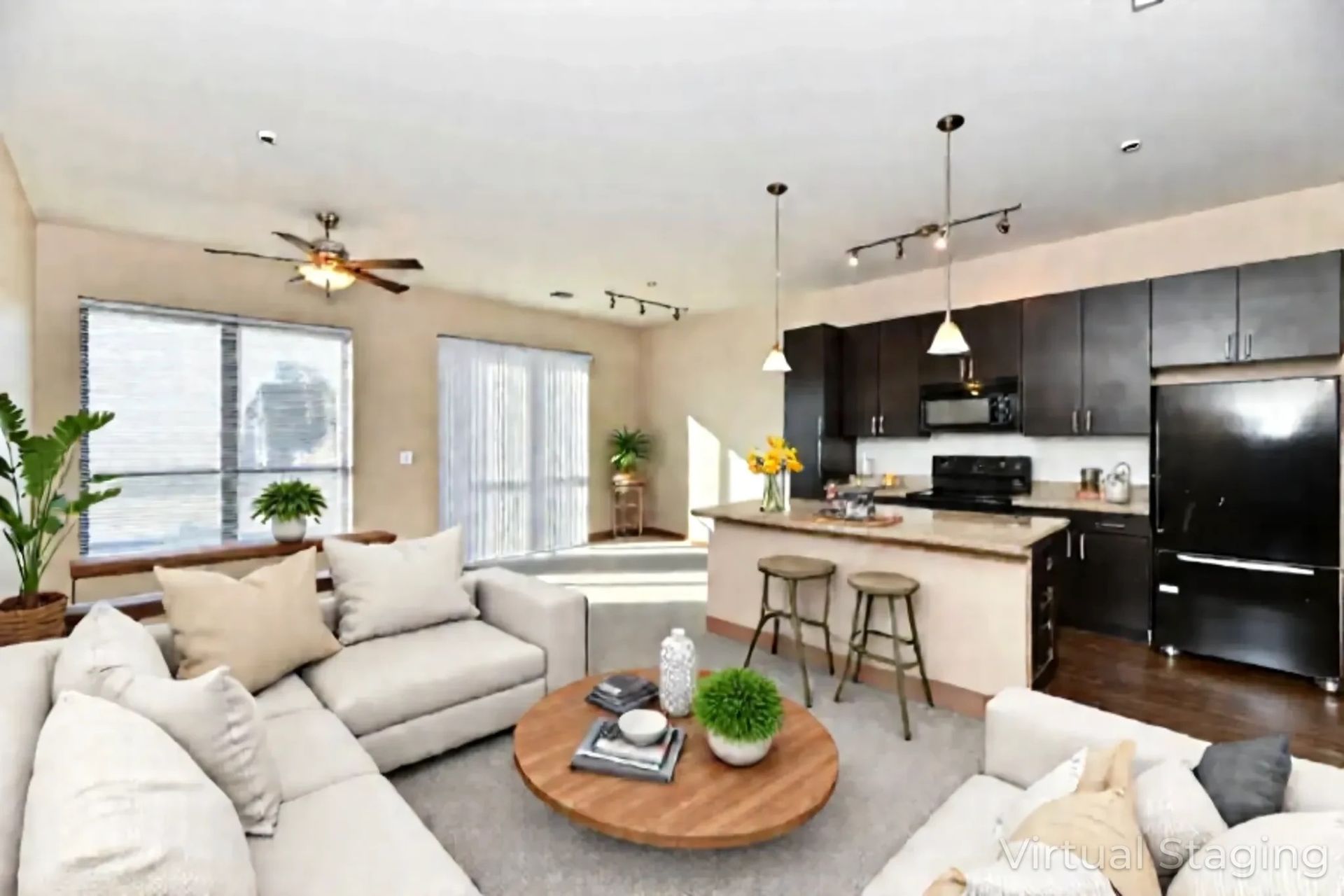 A living room with a couch , chairs , a table and a ceiling fan.