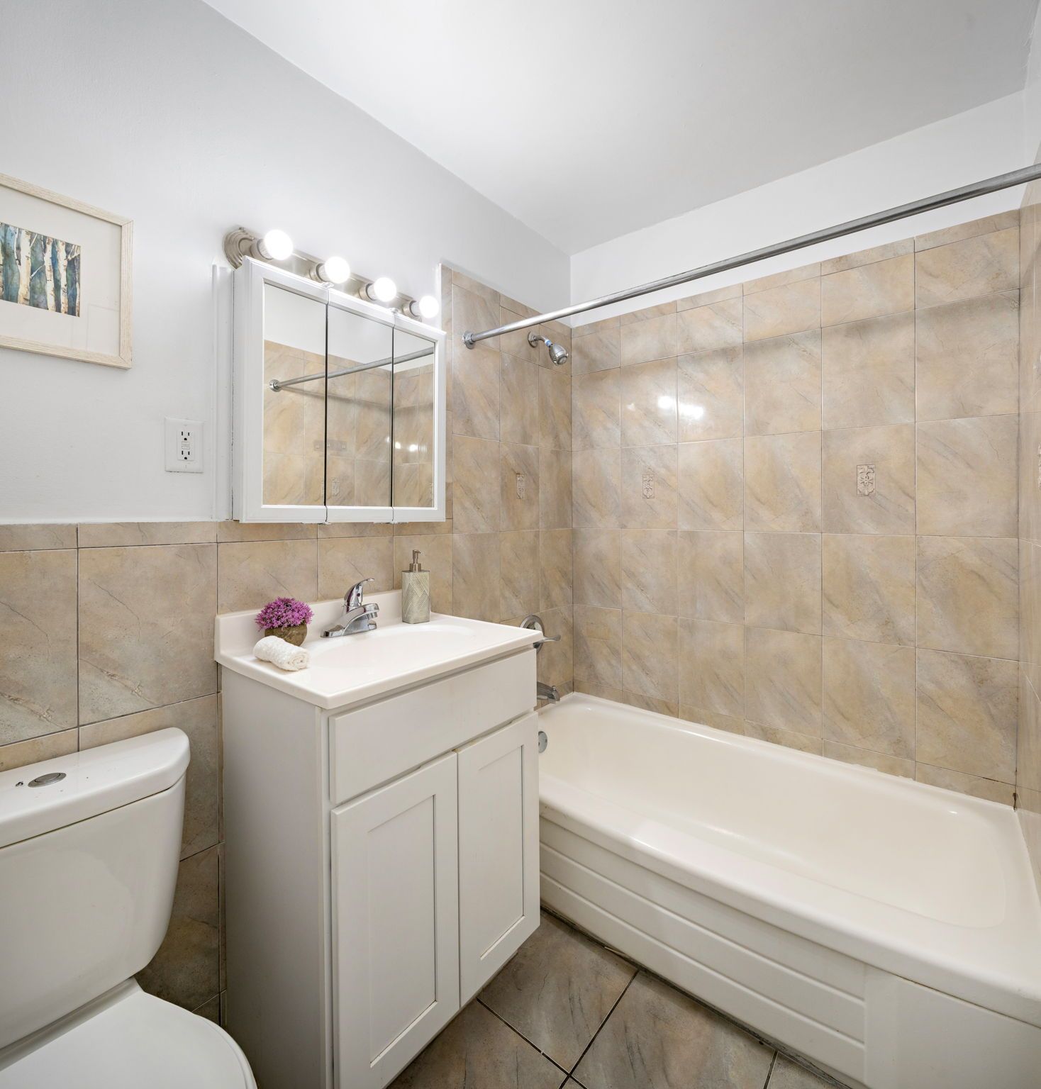 A renovated bathroom with a toilet a sink and a bathtub
