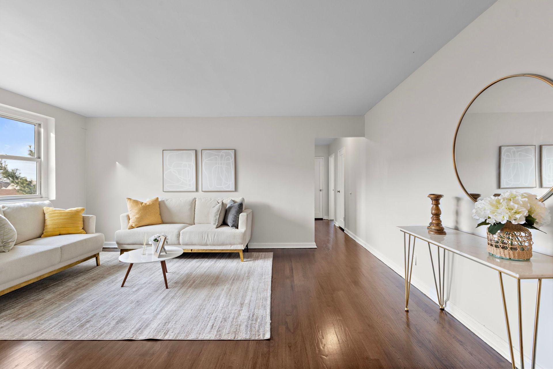 A living room with a couch , table , and mirror.