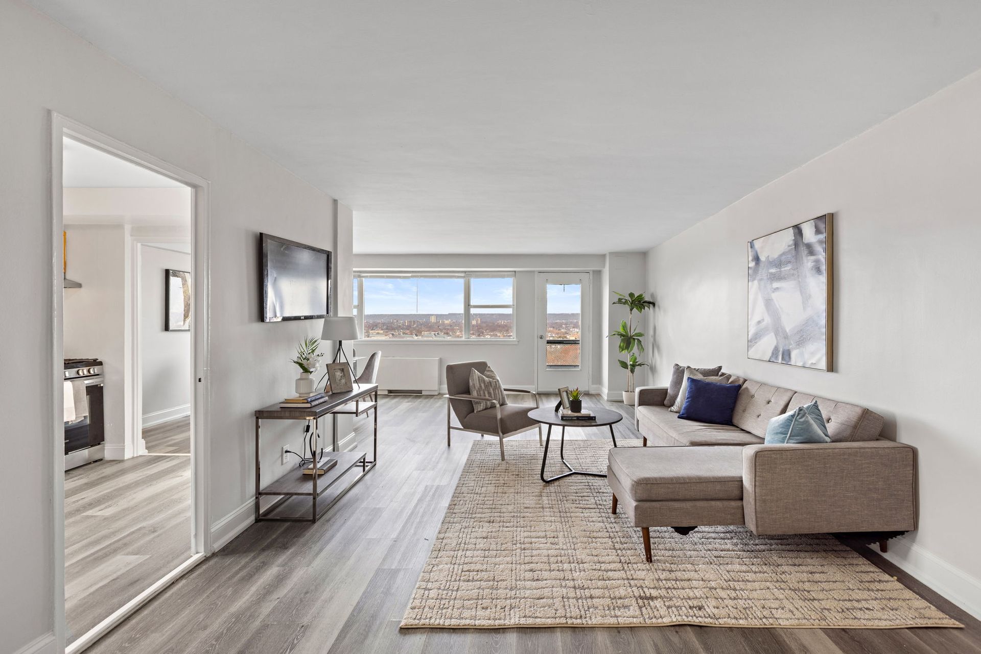 A living room with a couch , chairs , and a television.